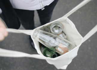 A canvas tote filled with glass bottles.