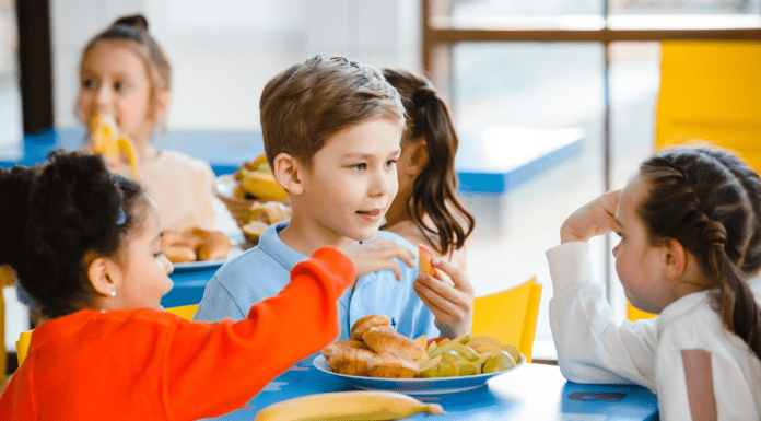 Child eating at school with friends