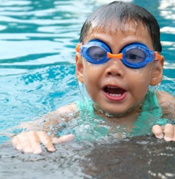 Young child with goggles swimming