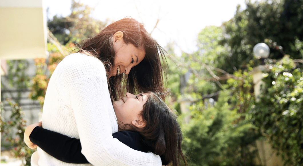 A mother and daughter embrace.