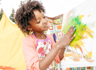 A girl paints her hand