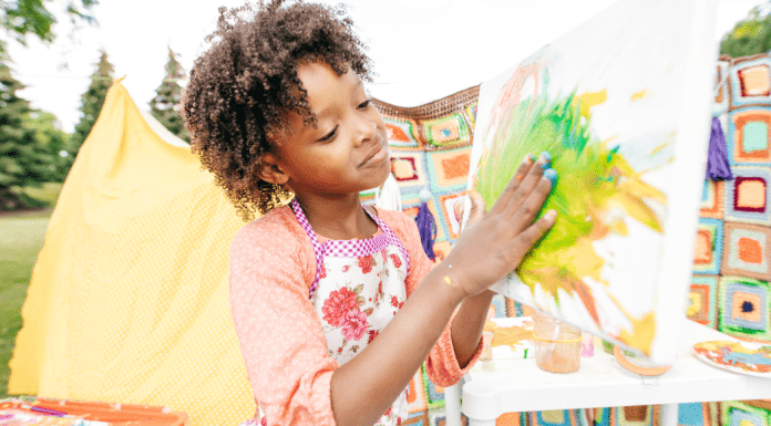 A girl paints her hand