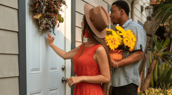 A woman knocks on the door and a man holds flowers.