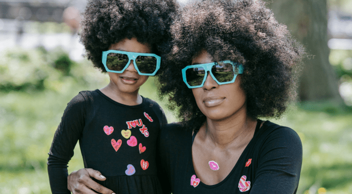 Mother and daughter in matching sunglasses and tshirts.