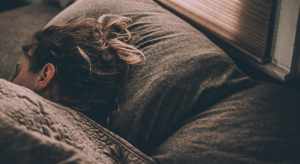 Woman sleeping in bed with only hair visible