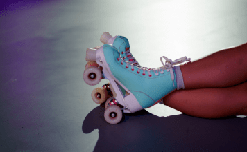 Girl roller skates with legs crossed