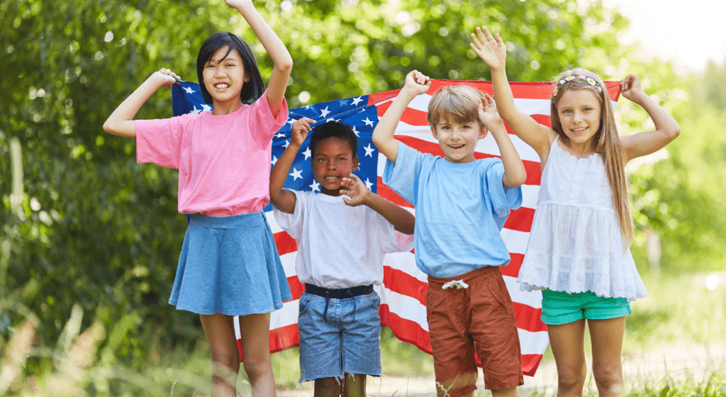 Children of different nationalities hold an American flag together.