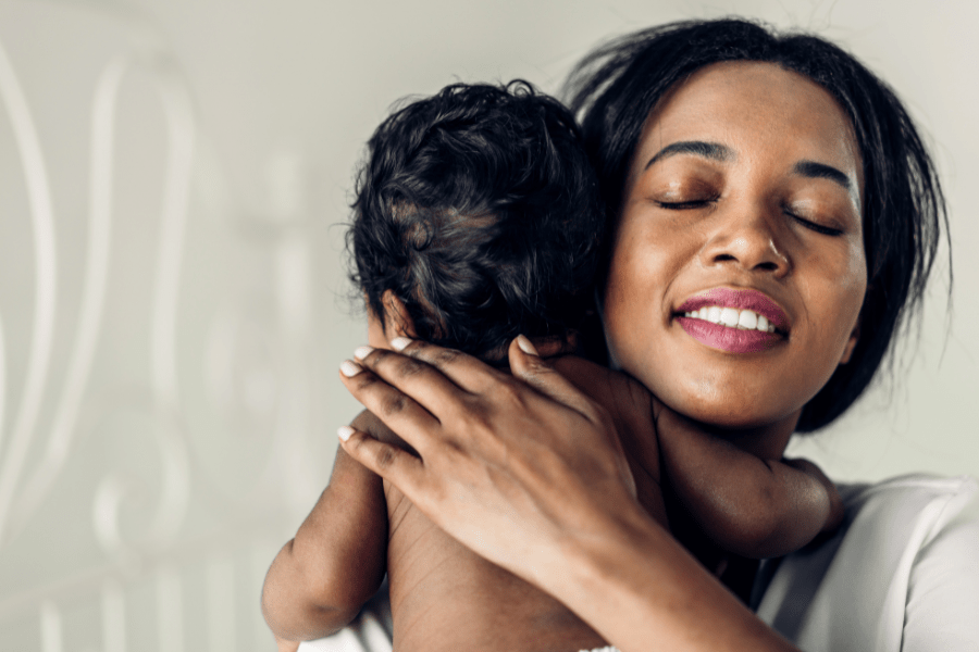 Mom breathes a sigh of relief as she burps and cares for newborn.