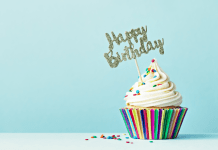 Cupcake with sprinkles and a "Happy Birthday" sign.