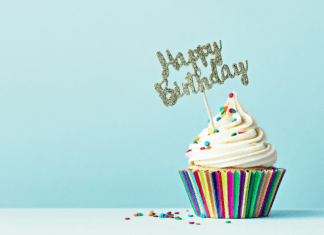 Cupcake with sprinkles and a "Happy Birthday" sign.