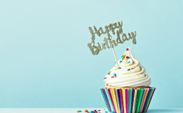 Cupcake with sprinkles and a "Happy Birthday" sign.