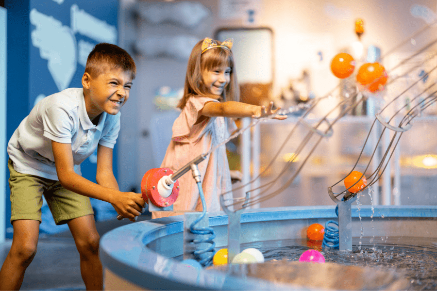 Kids playing with an interactive water machine at a museum