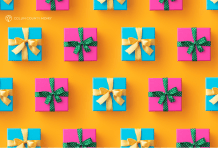 Presents wrapped in pink and blue with gold and green ribbons sit on a bright orange surface.