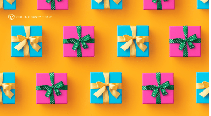 Presents wrapped in pink and blue with gold and green ribbons sit on a bright orange surface.