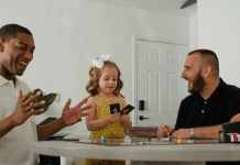 Biracial family with gay dads plays a card game for family game night