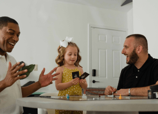 Biracial family with gay dads plays a card game for family game night