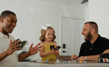 Biracial family with gay dads plays a card game for family game night