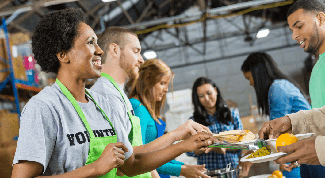 Volunteers serve meals at a food bank